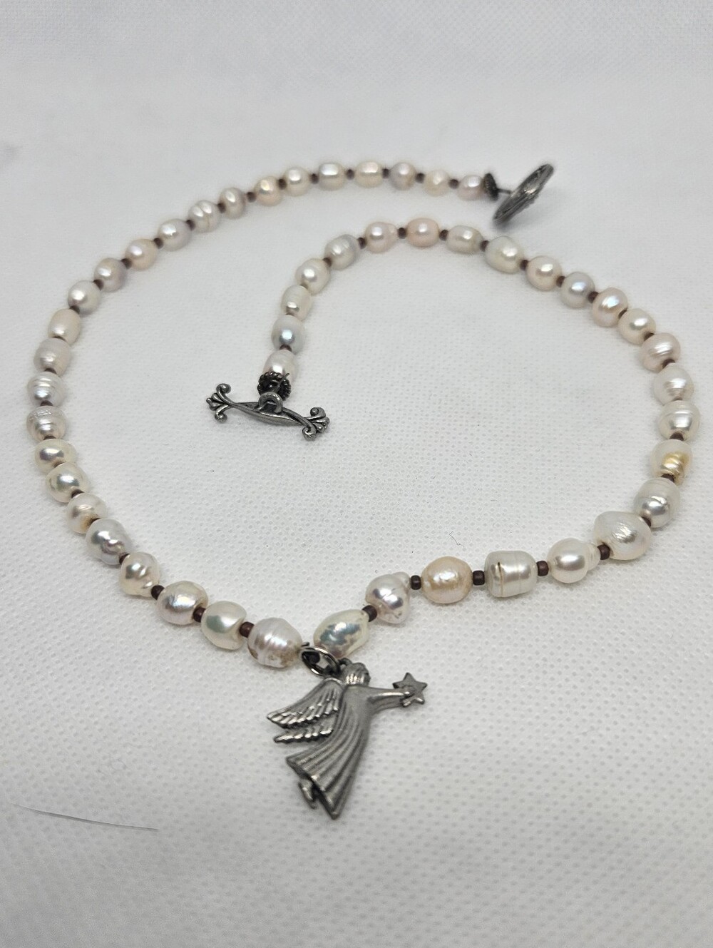 Handmade artisans , pink freshwater pearl necklace with removable pewter angel.